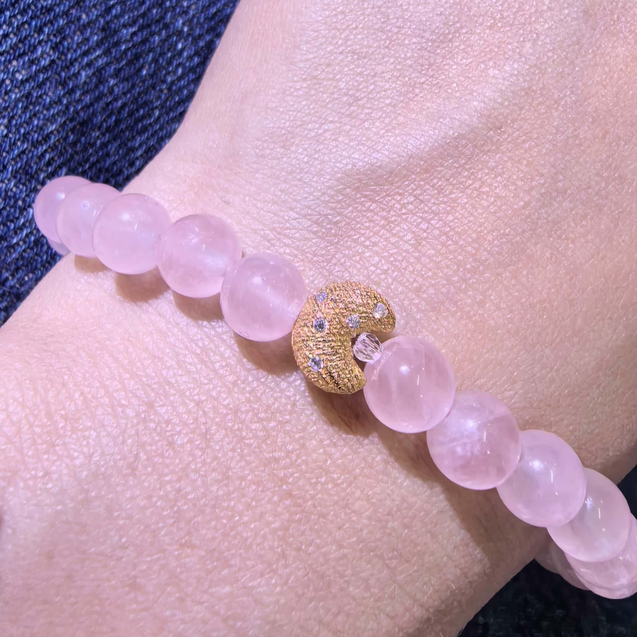 Close-up view of 24K gold-plated crescent moon charm on Self-Love Lunar Mantra Rose Quartz Bracelet
