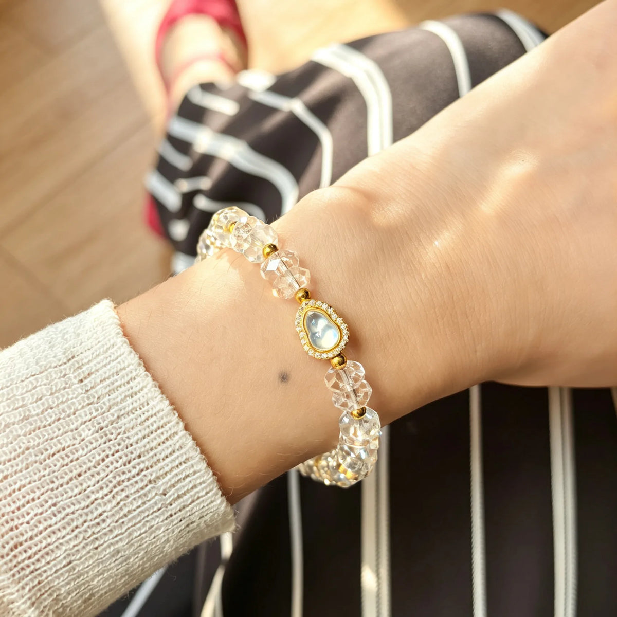 First light clear quartz bracelet wearing on woman's wrist.