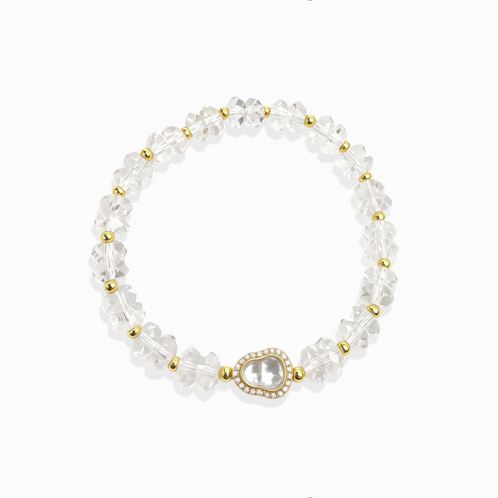 First light clear quartz bracelet white background, healing crystal for spiritual woman.