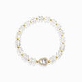 First light clear quartz bracelet white background, healing crystal for spiritual woman.