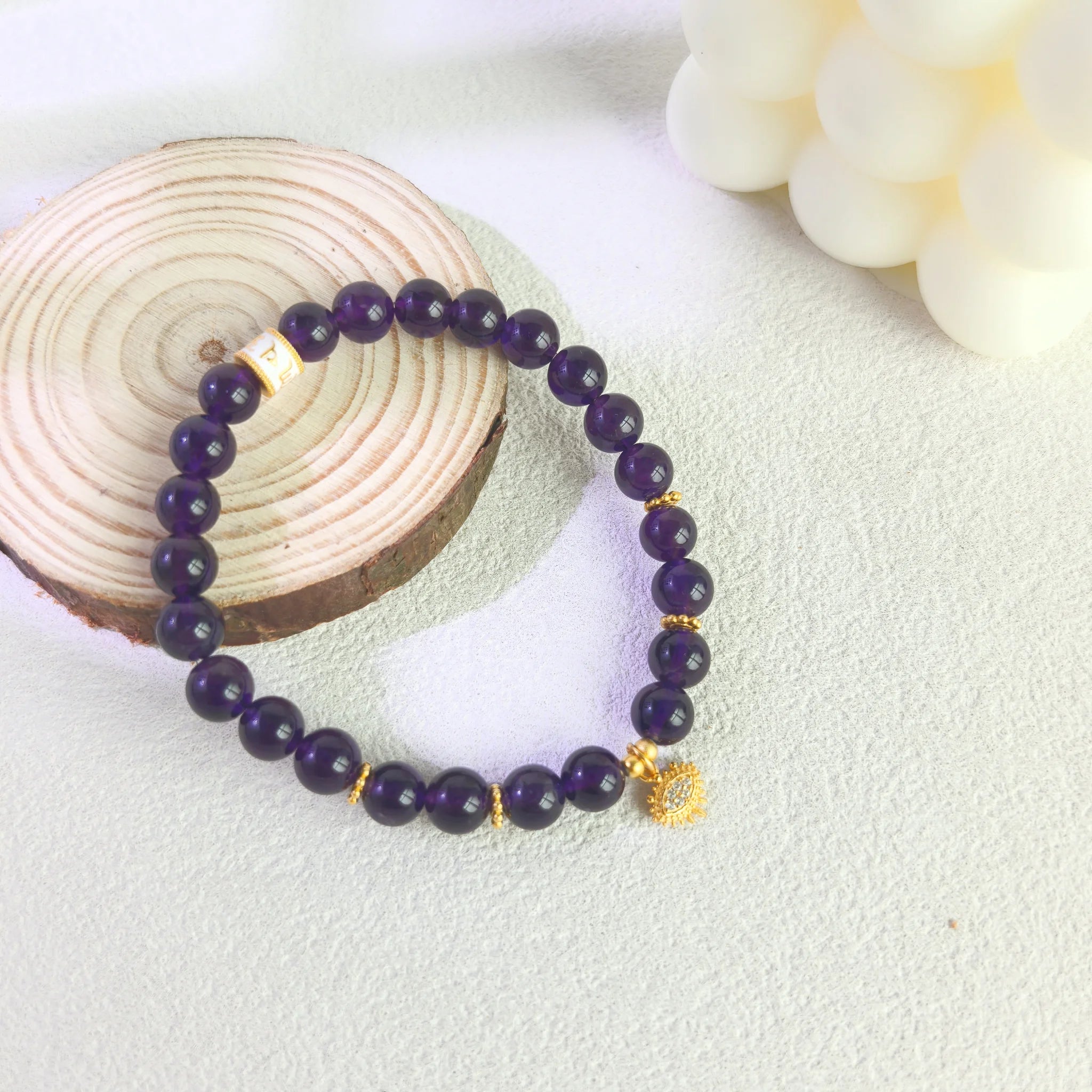 Soft ins style still life styling of Amethyst Aura Evil Eye Bracelet, anxiety relief crystal spiritual jewelry.