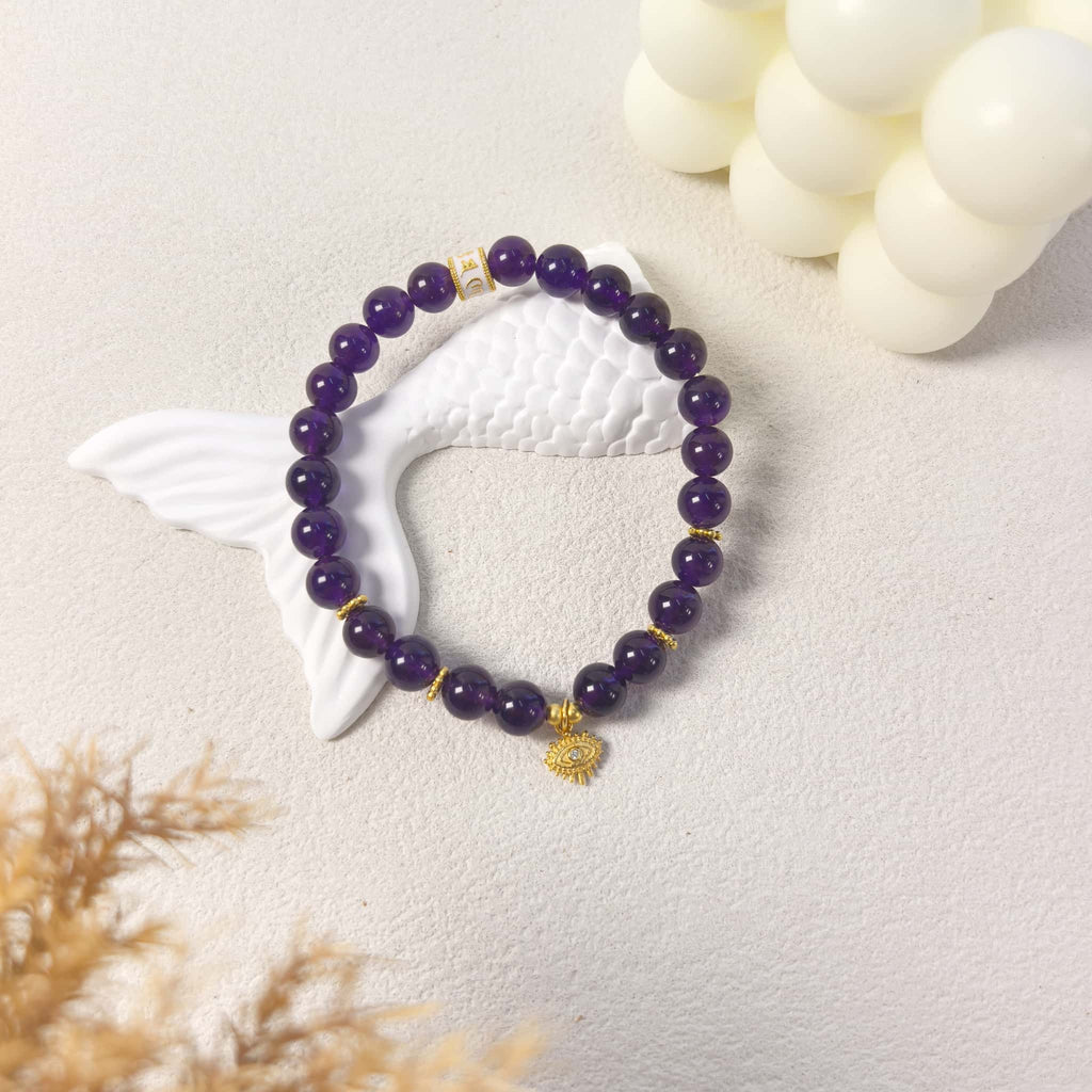 Ins style still life styling of Amethyst Aura Evil Eye Bracelet, intuition purple aura crystal jewelry for daily wear.