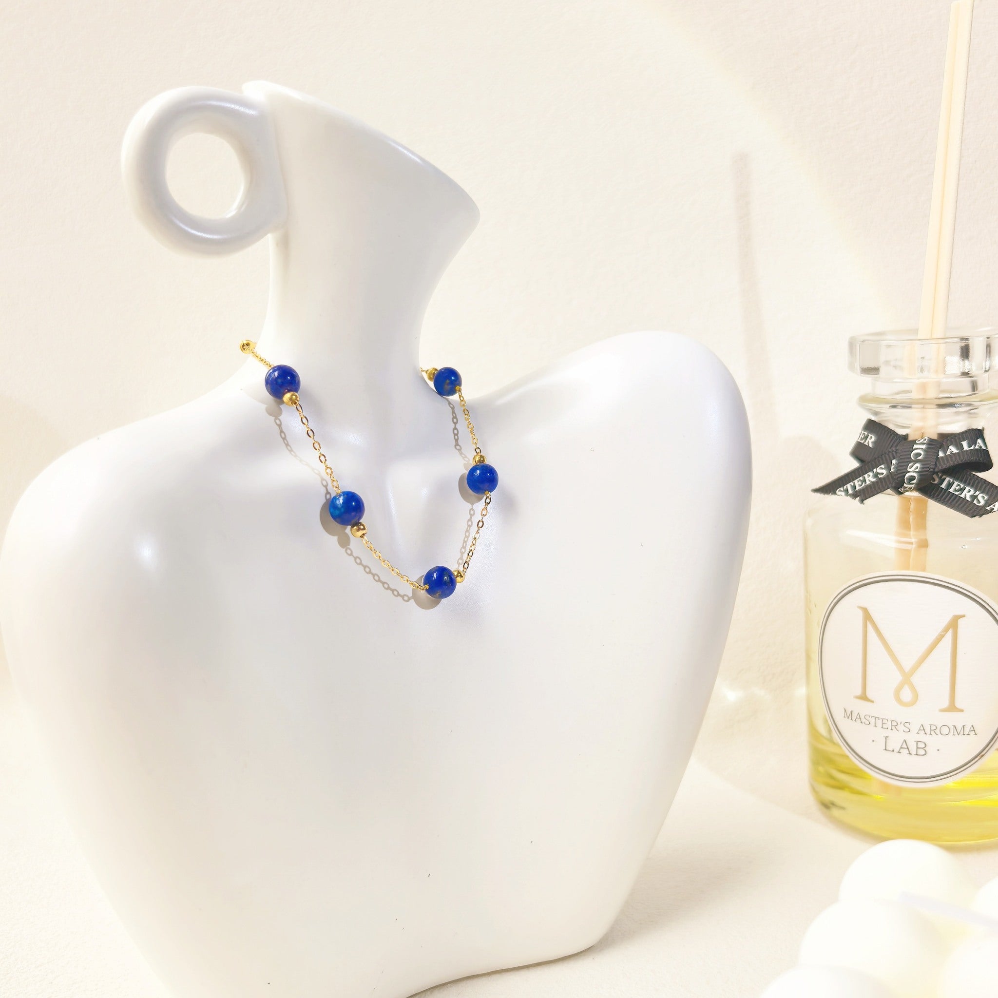 Ins style still life shot of Milky Way Stroll Lapis Lazuli Bracelet, placed on a vase. It's a perfect gift for her.