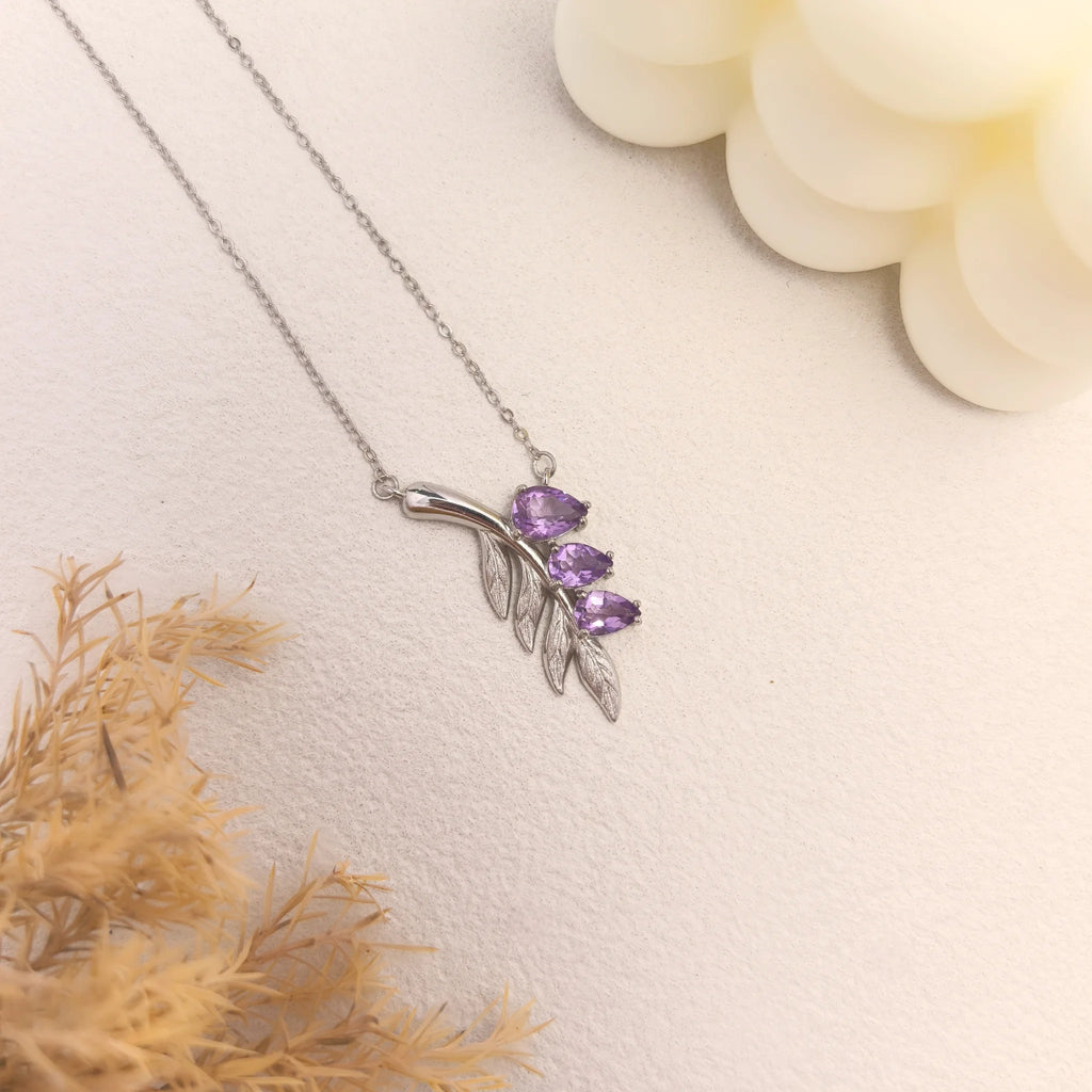 Aesthetic ins still life shot of lavender sprig amethyst silver necklace which bring calm and intuition during meditation.