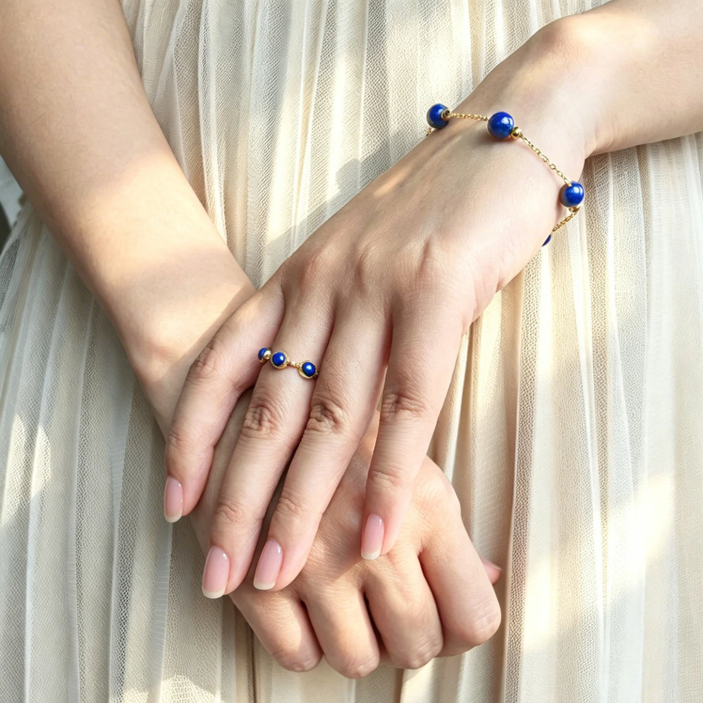 Female wearing dainty Milky Way Stroll Lapis Lazuli Bracelet on wrist, wisdom healing crystal for daily wear.