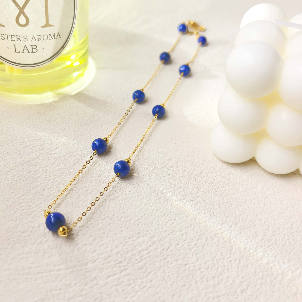 Ins aesthetic still life shot of Milky Way Stroll lapis lazuli necklace, celestial blue crystal jewelry flat lay decor