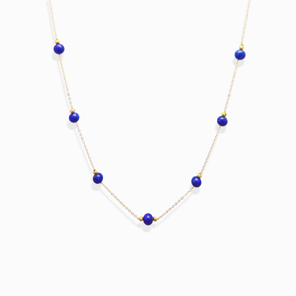 Dainty gold chain Milky Way Stroll lapis lazuli necklace, natural royal blue lapis bead choker isolated white background