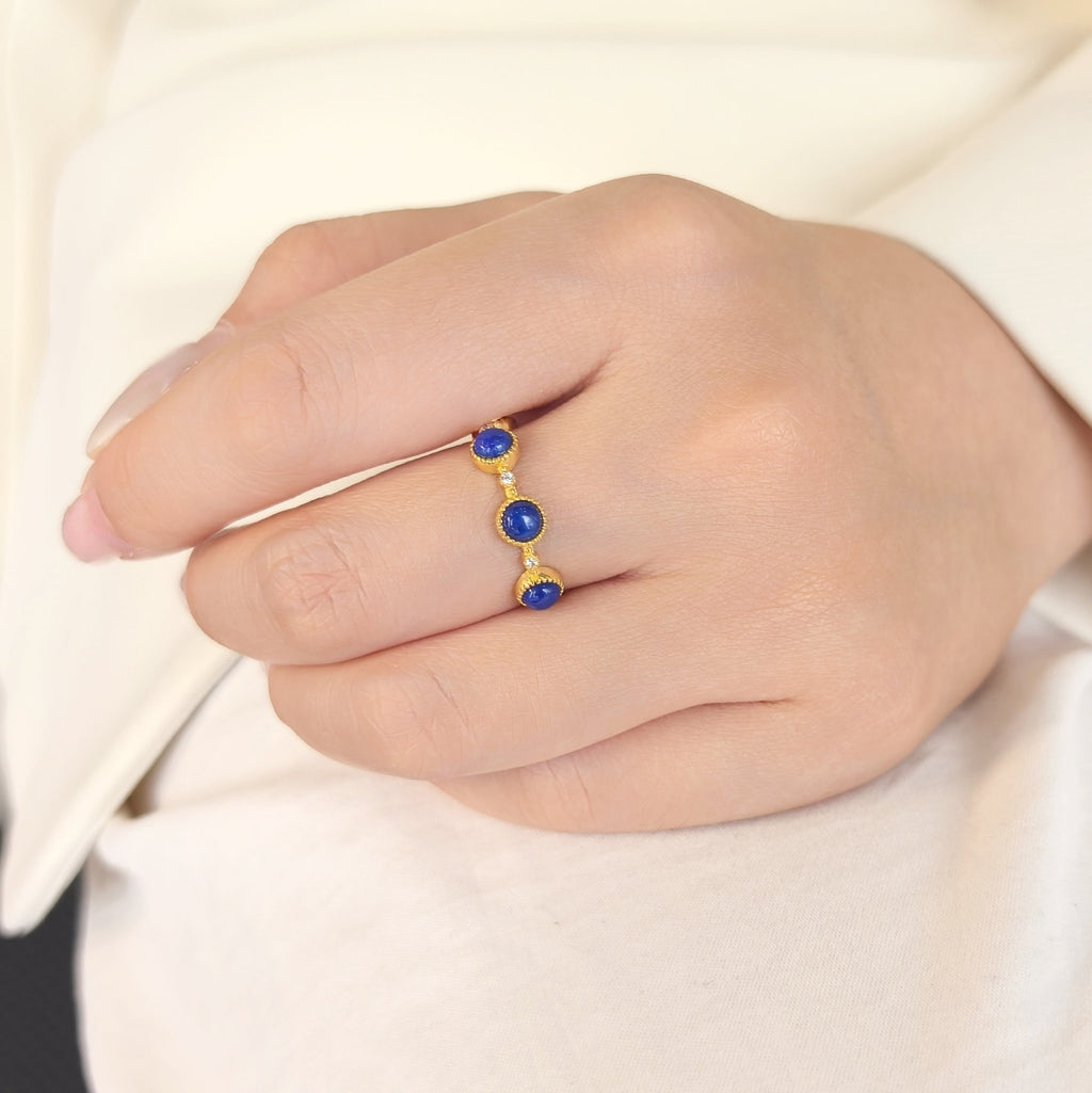 Woman wearing Milky Way Stroll lapis lazuli adjustable open band ring on finger, minimalist blue crystal stacking jewelry
