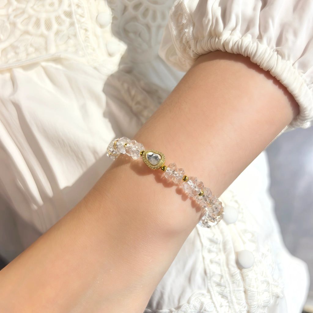 Woman wearing First Light Clear Quartz Bracelet dainty natural clear crystal wrist accessory everyday spiritual wear