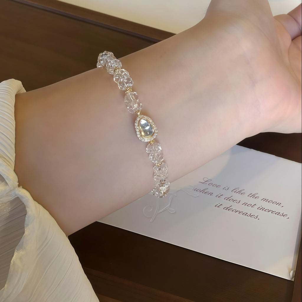 Woman wearing First Light Clear Quartz Bracelet, elegant look with it.
