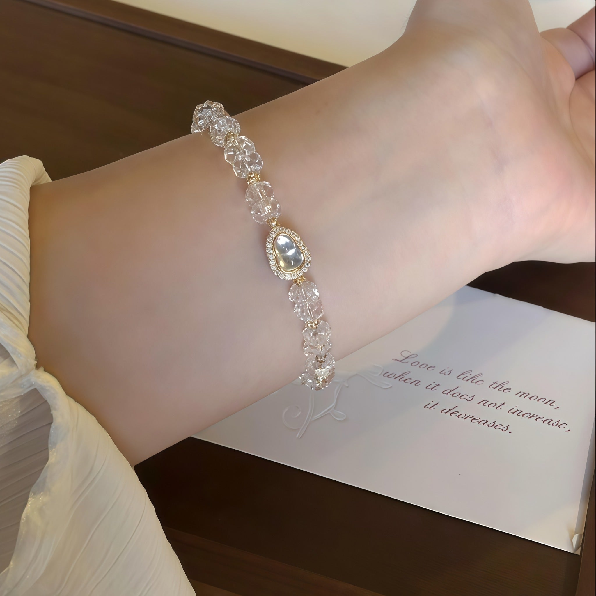 Woman wearing First Light Clear Quartz Bracelet, elegant look with it.