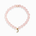 Rose quartz crescent moon charm bracelet healing jewelry on white background