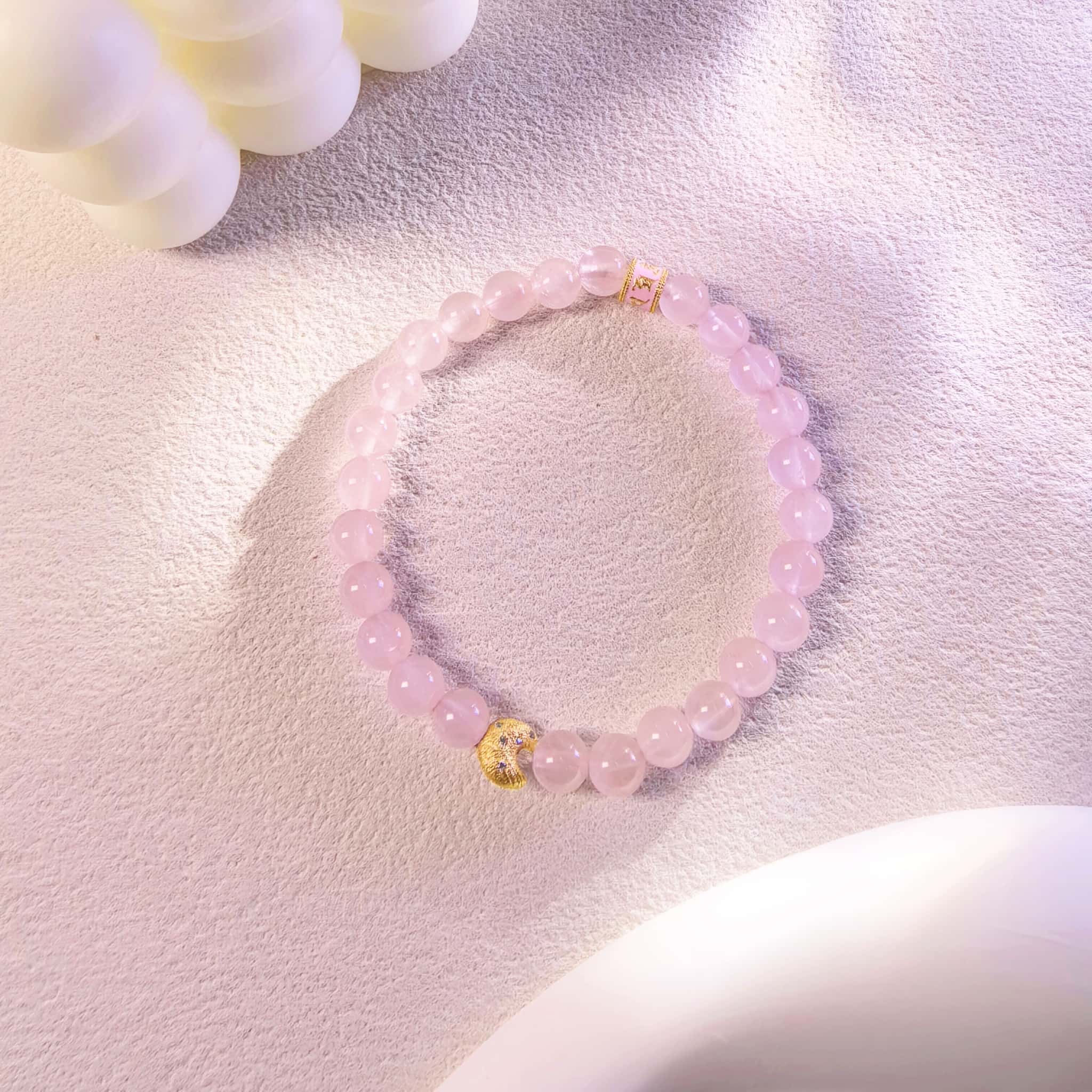Top view of Self-Love Lunar Mantra Rose Quartz Bracelet with shining light, healing spiritual crystal jewelry for women