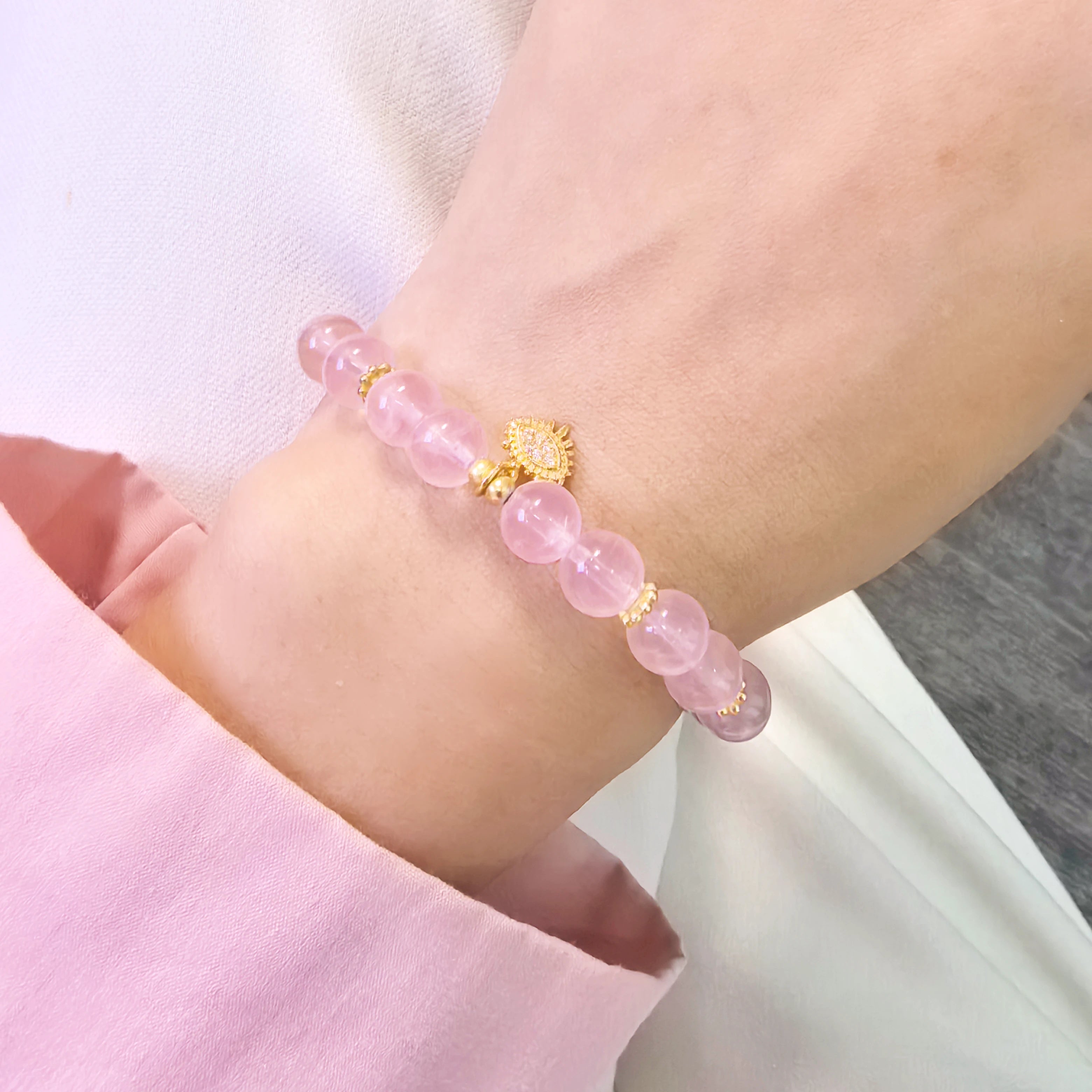 Woman wearing pink aura evil eye bracelet and show the other side of the evil eye