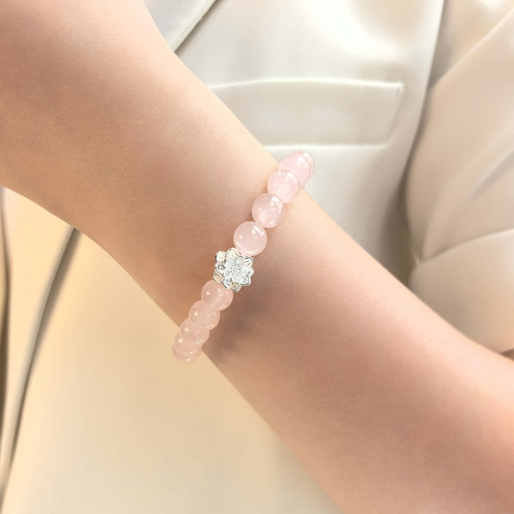 Women wearing Lotus Emotion Renewal Rose Quartz Bracelet, delicate floral witchy spiritual crystal wrist jewelry